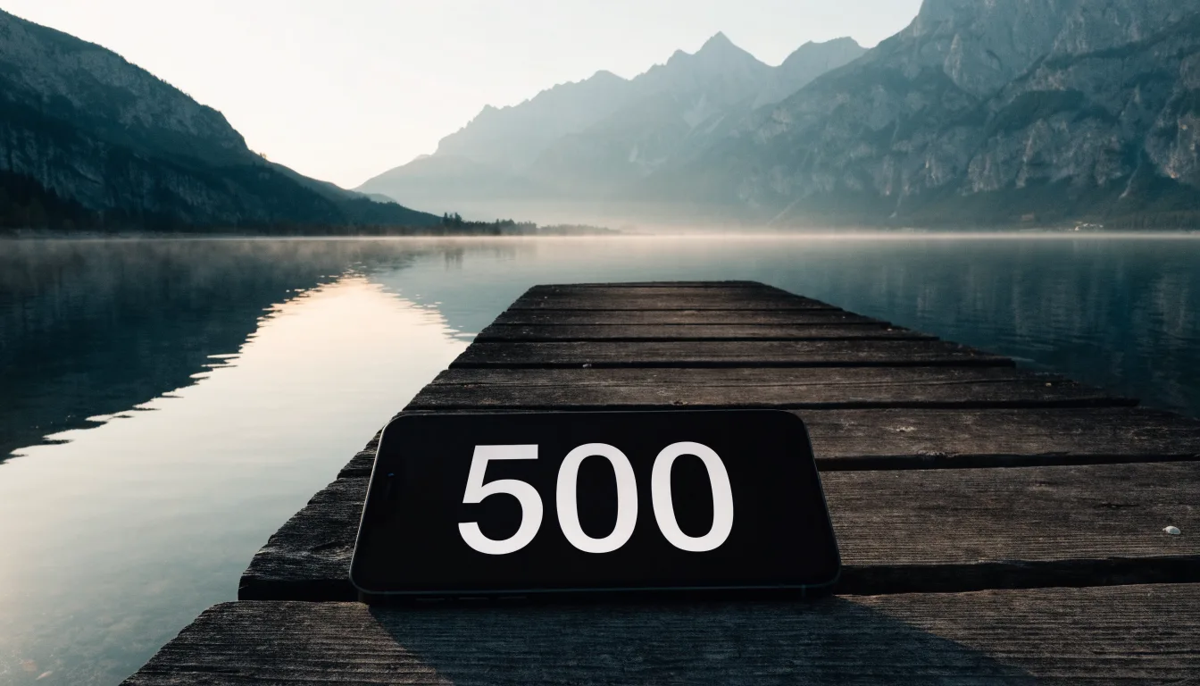 Ein Holzsteg führt über einen stillen Bergsee in den Alpen, über dem Wasser hängen bei Sonnenaufgang einzelne Nebelschwaden.
